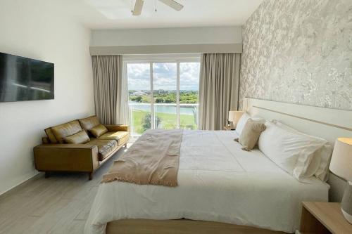 a bedroom with a large bed and a window at Beautiful Penthouse with private elevator in Hard Rock Golf in Punta Cana