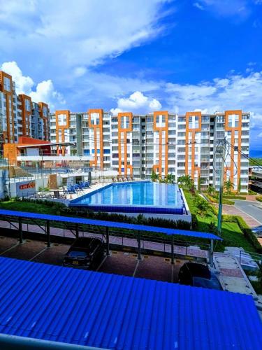 un gran edificio de apartamentos con una gran piscina en Apartamento Vacacional Familiar en Girardot, piscinas, Jacuzis, parqueadero privado, en Girardot