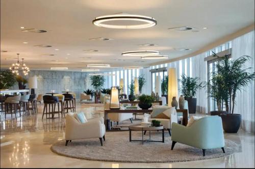 a lobby with couches and chairs and a table at Hotel Nacional Apart Lux in Rio de Janeiro
