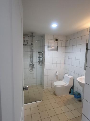 a bathroom with a toilet and a sink at Grand Beach Condo A207 in Ban Tha Fat