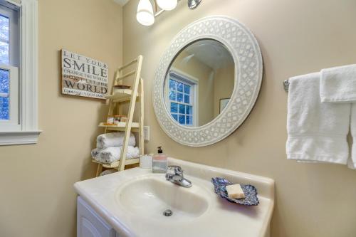 a bathroom with a sink and a mirror and towels at Idyllic and Central New Bern Home with Screened Porch! in New Bern