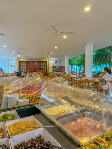 a buffet with many different types of food on display at Tamaca Beach Resort in Santa Marta
