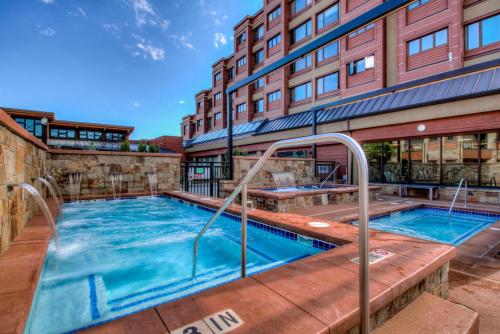 a swimming pool in front of a building at Village at Breckenridge Resort in Breckenridge