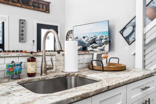 a kitchen with a sink and a counter top at Stella Boona Loft Traverse close to Trail and beach in Traverse City