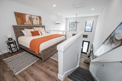 a bedroom with a large bed and a staircase at Stella Boona Loft Traverse close to Trail and beach in Traverse City