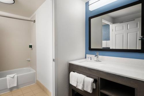 a bathroom with a sink and a mirror at Residence Inn by Marriott Anaheim Resort Area/Garden Grove in Anaheim