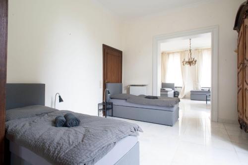 a bedroom with two beds and a living room at Apartment in stylish city villa in Goch