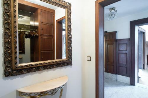 a mirror hanging on a wall next to a hallway at Apartment in stylish city villa in Goch