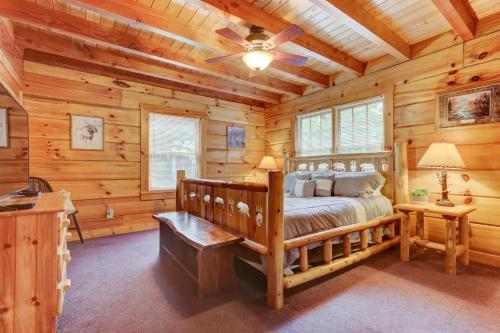 a bedroom with a bed in a log cabin at LUX 4BD Lodge w/ Views! Fire Pits + HOT TUB + Pool in Gatlinburg