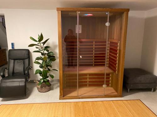 a wooden cabinet with glass doors in a room at Ferienhaus Sönnchen in Schleiden