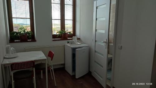a small kitchen with a table and a table and chairs at Villa Homestay Nad Helmrovkou in Prague