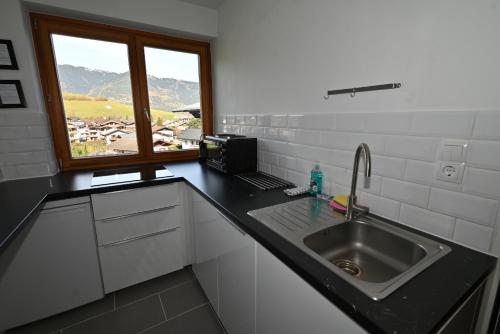 a kitchen with a sink and a window at Apartement Karen TOP 35 - by Four Seasons Apartments in Kaprun