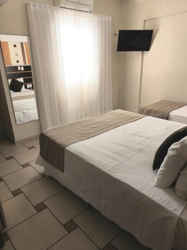 Postel nebo postele na pokoji v ubytování Hotel Ferraz
