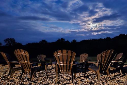 a group of chairs and a table on a beach at GameRoom, HotTub, Piano, 5mi to OldManCave - Hocking Hills Copper House in Laurelville