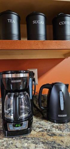 a coffee maker on a counter next to a coffee pot at GameRoom, HotTub, Piano, 5mi to OldManCave - Hocking Hills Copper House in Laurelville