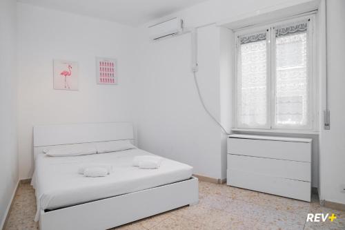 a white room with a bed and a window at Piazza Bologna Holiday House in Rome