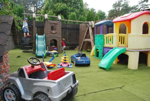 a childrens play area with toys on the grass at Villa Anna in Apšuciems