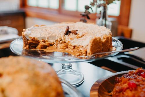 a cake on a glass plate on a table at WoodStone Hotel Fazenda in Gramado