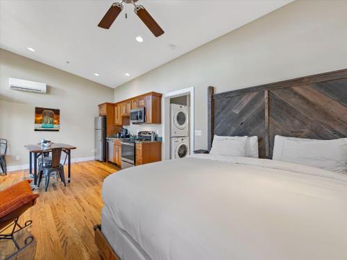 a bedroom with a large bed and a kitchen at Pilot Cove in Pisgah Forest