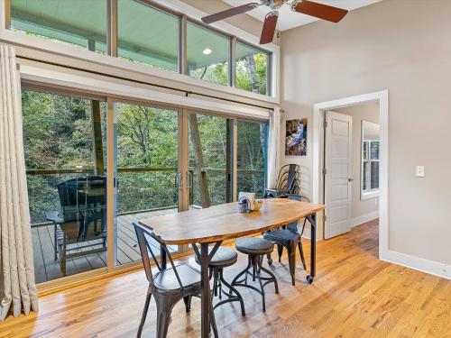 a dining room with a wooden table and chairs at Pilot Cove in Pisgah Forest