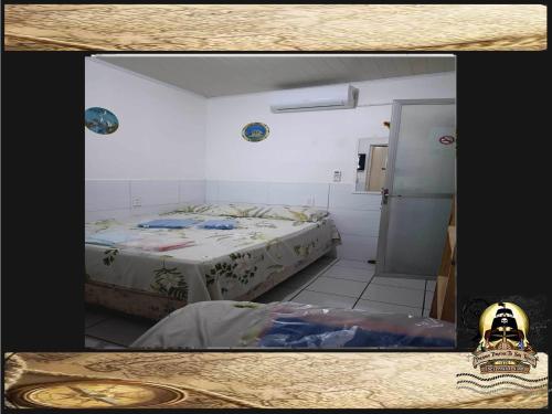 a room with a bed and a table in it at Pousada Piratas Di San Rocco in Maceió