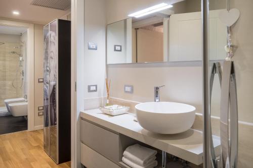 a white bathroom with a sink and a shower at Flats4Rent Federica in Verona