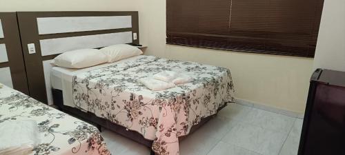 ein kleines Schlafzimmer mit 2 Betten und einem Fenster in der Unterkunft La Palma Hotel Fazenda in Indaiatuba