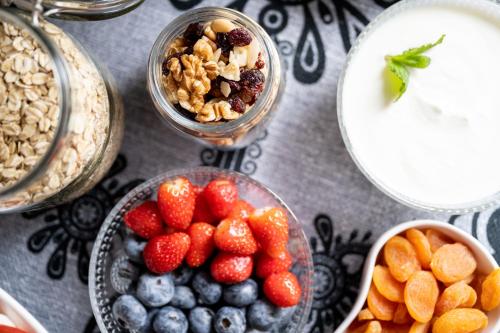 a table topped with bowls of fruit and granola at Panorama Premium in Kościelisko