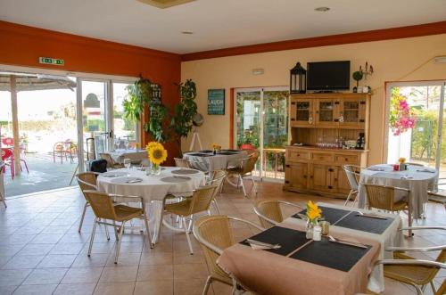 a restaurant with tables and chairs in a room at Four Bedroom Villa with private pool Oasis Parque AT09 in Portimão