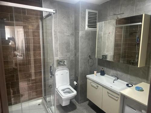 a bathroom with a shower and a toilet and a sink at Apartment with nice View in Beylikduzu