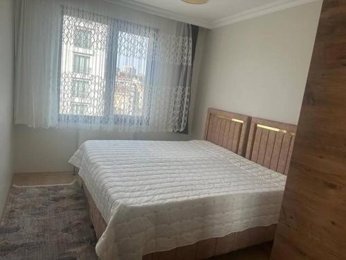 a bedroom with a bed and a window at Apartment with nice View in Beylikduzu
