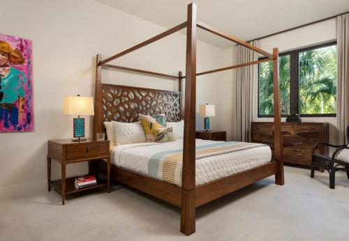 a bedroom with a four poster bed and a window at Clevelander in Long Bay Hills