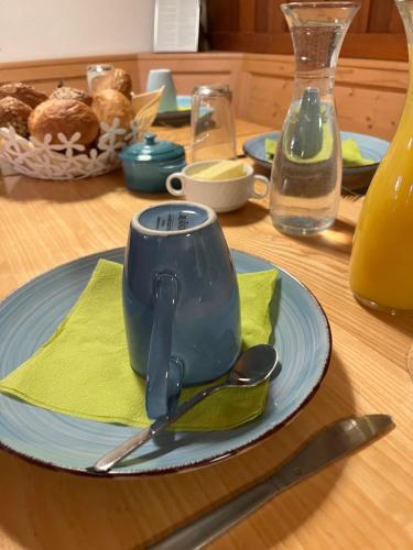 a blue coffee cup on a plate on a table at Sporthostel Rössle in Schluchsee