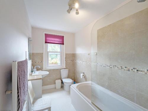 a bathroom with a tub and a toilet and a sink at Thorney Road in Emsworth