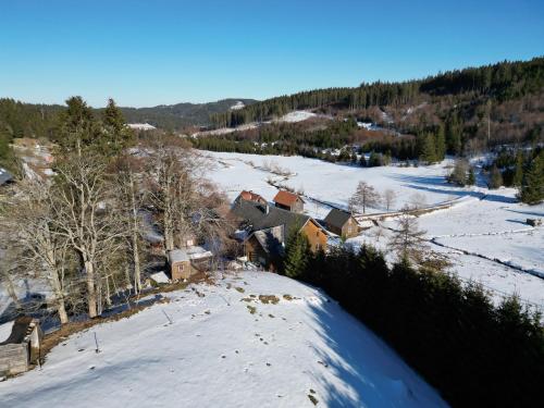 an aerial view of a house in the snow at Sporthostel Rössle in Schluchsee