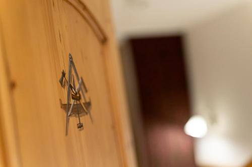 a clock on the side of a door at Camana Veglia in Livigno