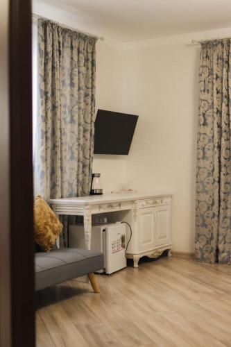 a living room with a table and a tv at Готель Хутір in Malyye Khutora