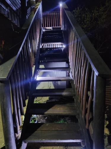a set of stairs with lights on them at night at Amare Cabin in the bush with all your needs! in Marloth Park