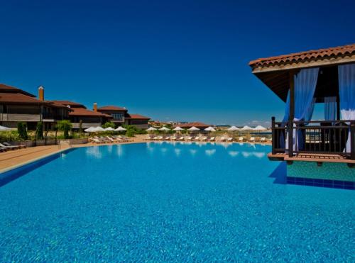 a large blue swimming pool with a resort at Sozopol Созопол- SOZOPOLIS -MORE SUN 2А- in Sozopol