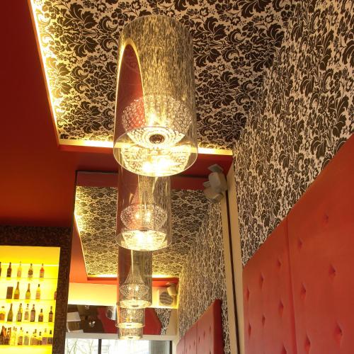 a chandelier hanging from the ceiling in a restaurant at Cityhotel am Thielenplatz in Hannover