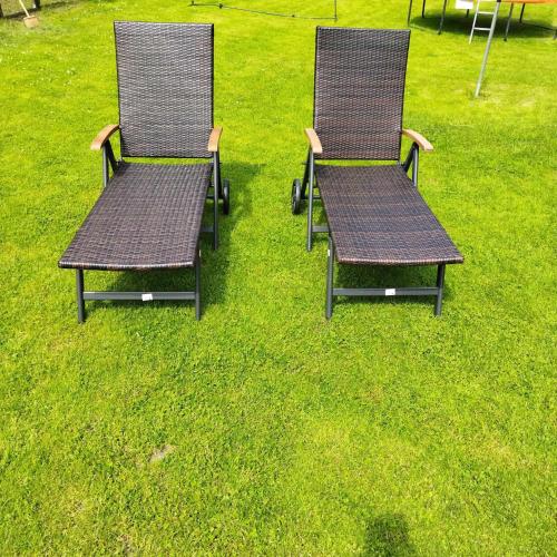 two chairs sitting in the grass in a field at Ubytování Pod statkem in Tichá