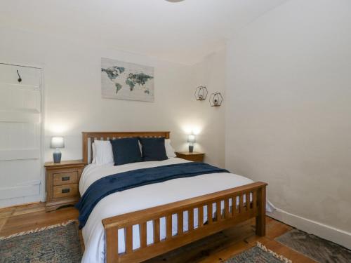 a bedroom with a large bed with blue pillows at Builth House in Abergavenny