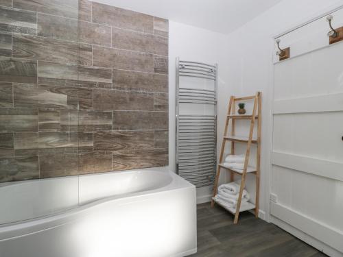 a bathroom with a bath tub and a ladder at Builth House in Abergavenny