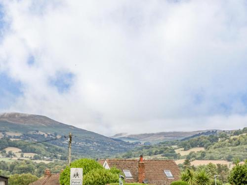 a view of a town with mountains in the background at Builth House in Abergavenny