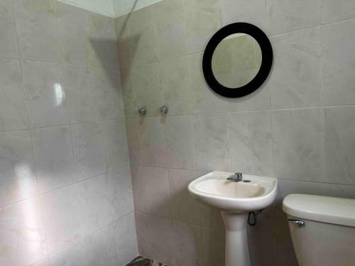 a bathroom with a sink and a mirror on the wall at Posada chachalacas in Chachalacas