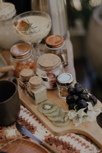 a wooden table with jars of food on it at Vila Cerrado in Alto Paraíso de Goiás
