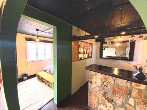 a room with a bar and a room with a counter at Donde Pepe Loft Apartasuite. in Zipaquirá