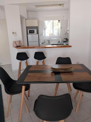a kitchen with a table and chairs in a room at Villa Margo by the Sea in Paphos City
