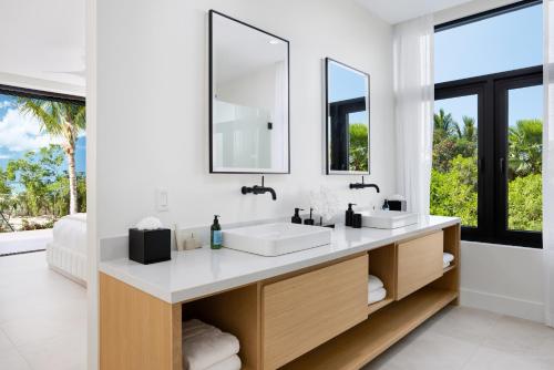 a bathroom with two sinks and a large mirror at Beachwood Villa in Turtle Cove