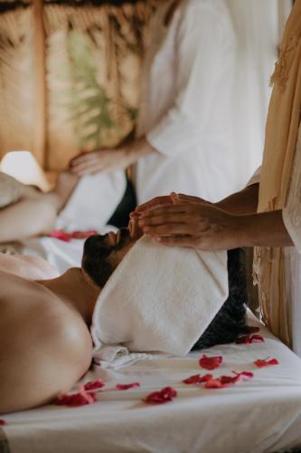 a woman is laying on a bed with a towel at Vila Cerrado in Alto Paraíso de Goiás